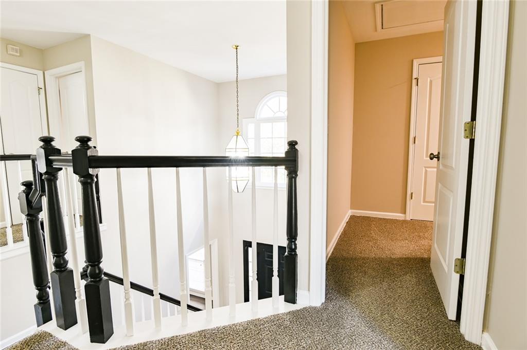 2670 Factor Walk Boulevard Suwanee, GA 30024 - Photo 20 of 57 a view of a hallway with wooden floor and staircase
