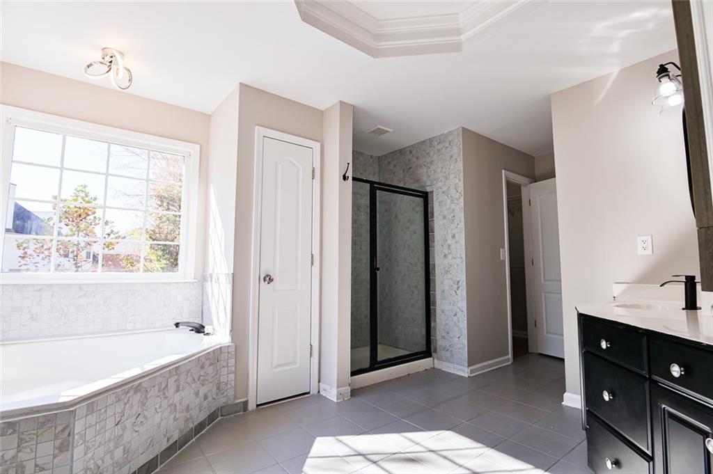 2670 Factor Walk Boulevard Suwanee, GA 30024 - Photo 26 of 57 a spacious bathroom with a tub shower and sink