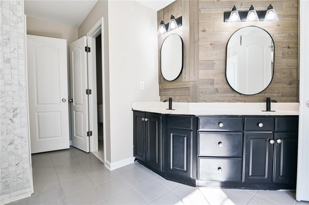 2670 Factor Walk Boulevard Suwanee, GA 30024 - Photo 27 of 57 a bathroom with a double vanity sink mirror and shower