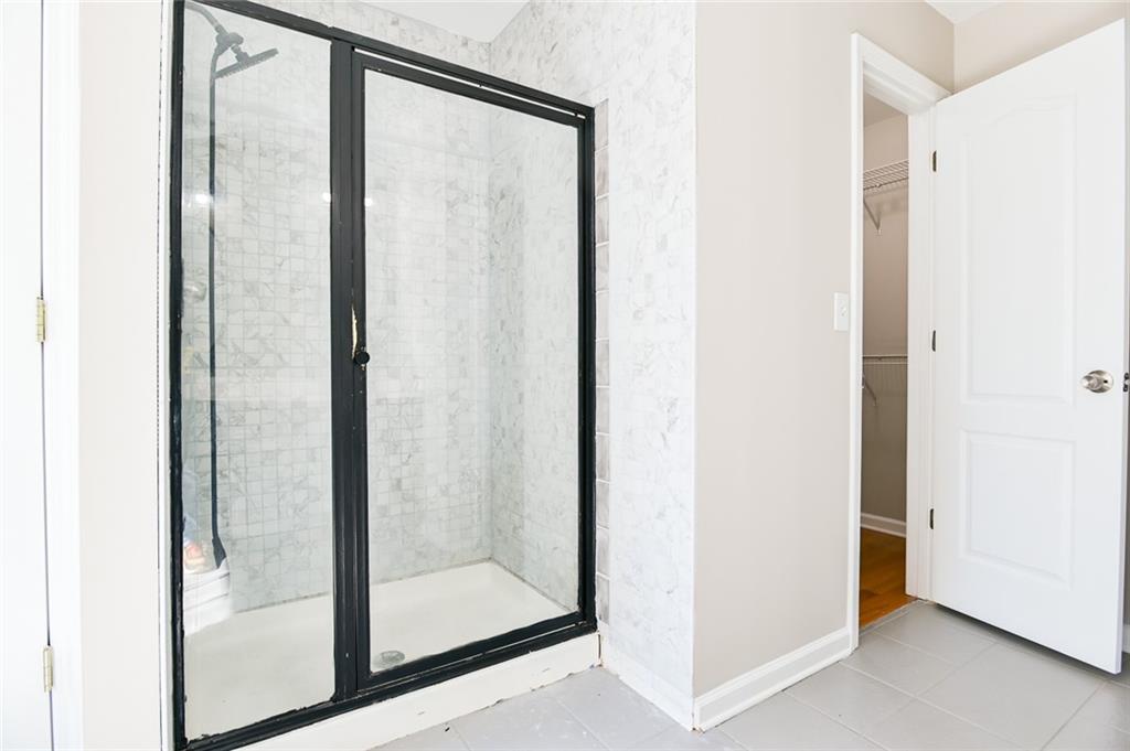 2670 Factor Walk Boulevard Suwanee, GA 30024 - Photo 28 of 57 a bathroom with a glass shower door
