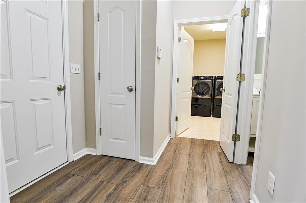 2670 Factor Walk Boulevard Suwanee, GA 30024 - Photo 48 of 57 a view of a hallway with wooden floor and a living room