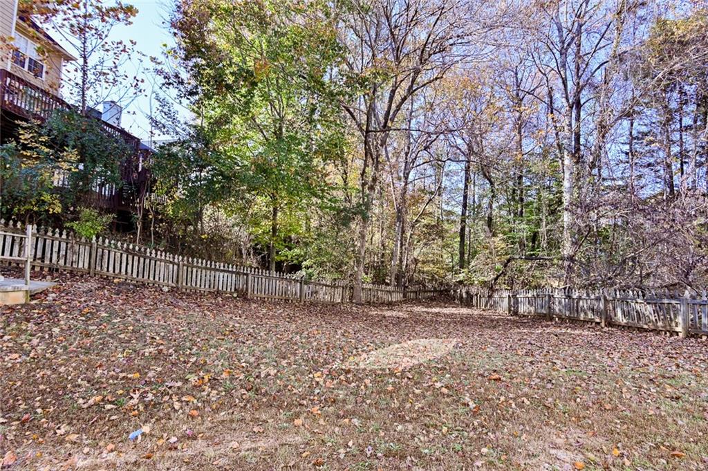 2670 Factor Walk Boulevard Suwanee, GA 30024 - Photo 50 of 57 a view of backyard with wooden fence and large trees