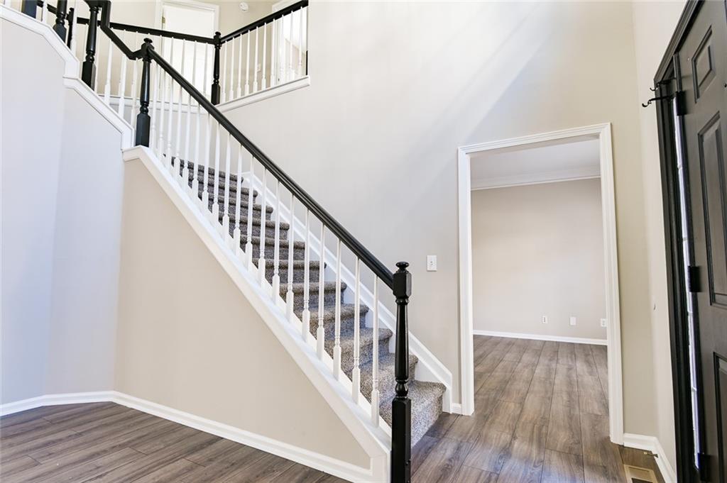 2670 Factor Walk Boulevard Suwanee, GA 30024 - Photo 5 of 57 a view of staircase with wooden floor and white walls