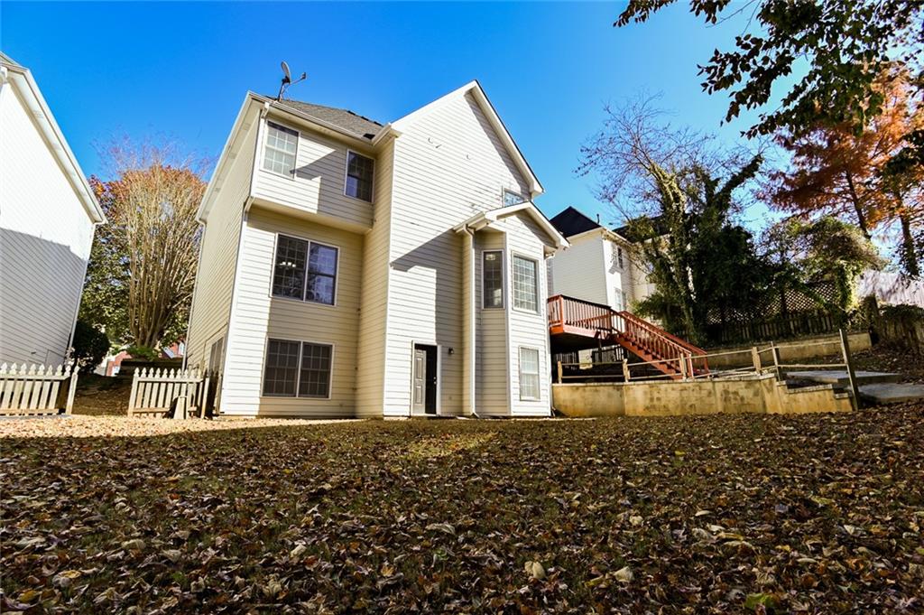 2670 Factor Walk Boulevard Suwanee, GA 30024 - Photo 52 of 57 a view of a large house with a large tree and wooden fence