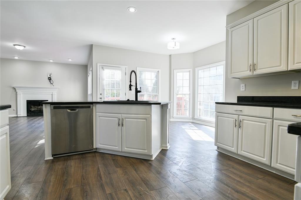 2670 Factor Walk Boulevard Suwanee, GA 30024 - Photo 8 of 57 a kitchen with stainless steel appliances granite countertop a sink a stove a refrigerator and white cabinets