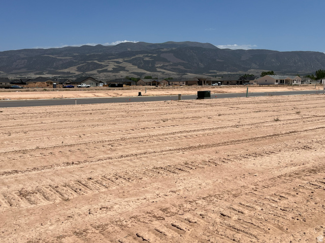 5107 North 75 East, Unit 207 Enoch, UT 84721 - Photo 4 of 13 Expansive undeveloped land parcel featuring cleared ground with visible tire tracks