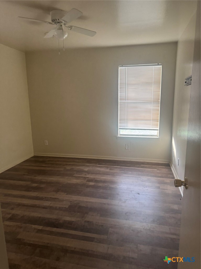 904 Houston Street Killeen, TX 76541 - Photo 5 of 17 an empty room with wooden floor and windows