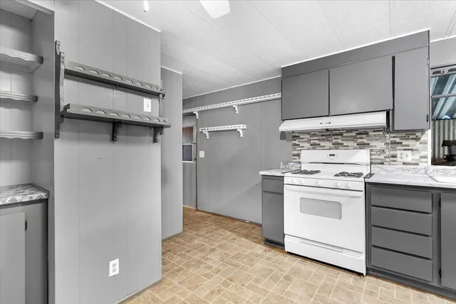 a kitchen with a stove and a refrigerator