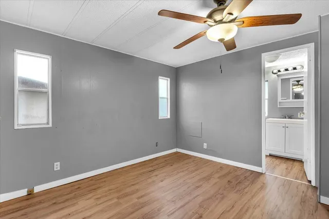 wooden floor in an empty room with a window
