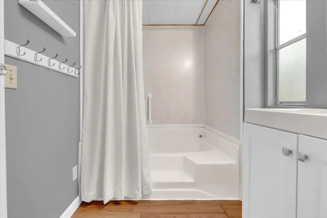 a bathroom with a bathtub and shower