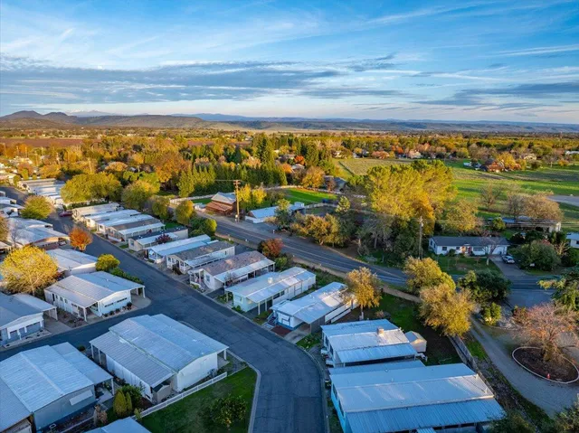 an aerial view of a houses with a city view