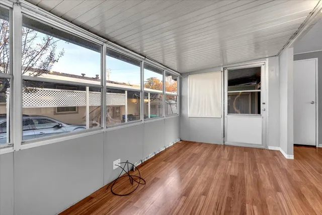 a view of an entryway with wooden floor