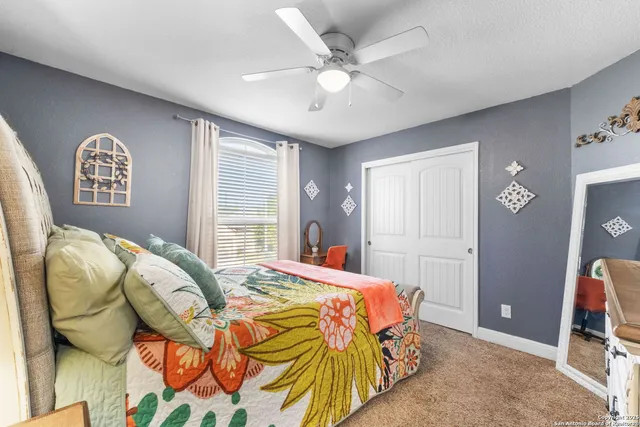 a bed sitting in a bedroom next to a window