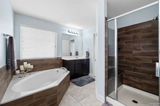 a bathroom with a tub a sink and a shower