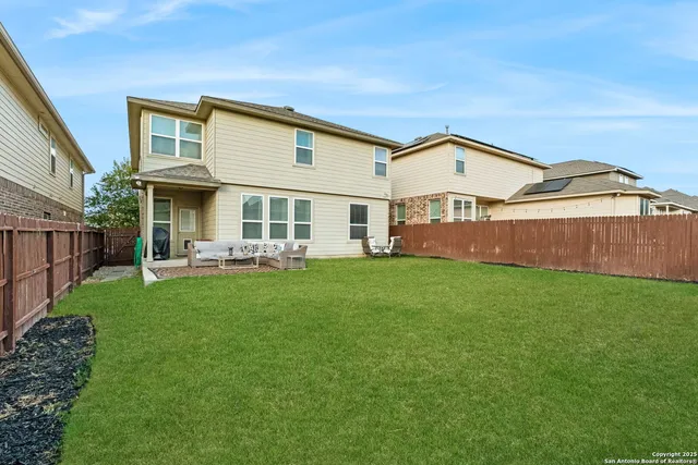 a front view of a house with a garden and yard