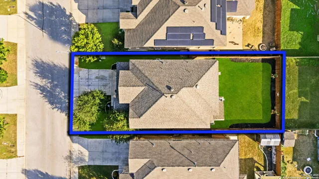 an aerial view of residential houses with outdoor space
