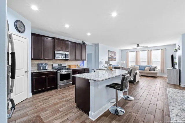 a kitchen with counter top space a sink appliances and cabinets