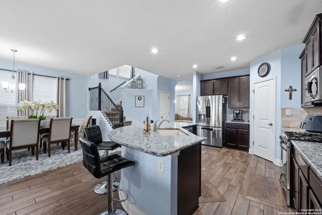 a view of kitchen with refrigerator microwave and wooden floor