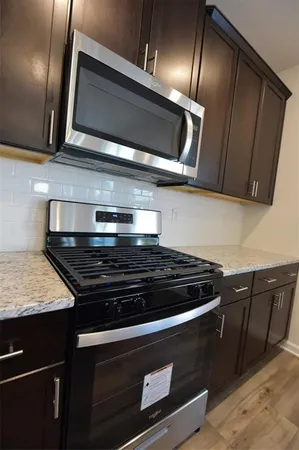 a stove top oven sitting inside of a kitchen
