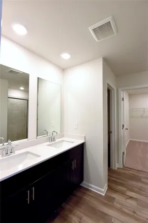 a bathroom with a double vanity sink and a mirror