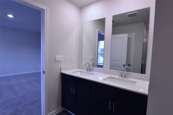 a bathroom with a double vanity sink and a mirror