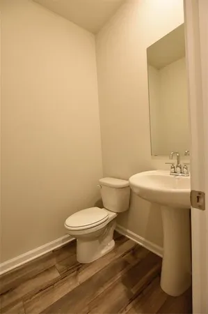 a white toilet sitting next to a bathroom sink
