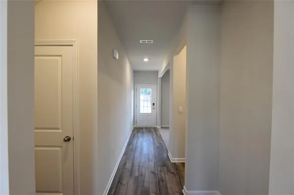 a view of hallway with wooden floor