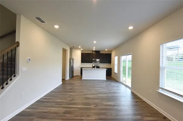 a view of a kitchen with a sink and wooden floor
