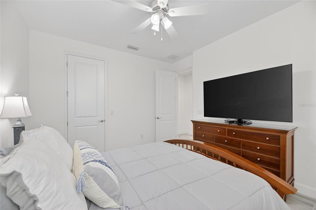 994 Signet Drive Apollo Beach, FL 33572 - Photo 44 of 98 a bedroom with a bed and a flat screen tv