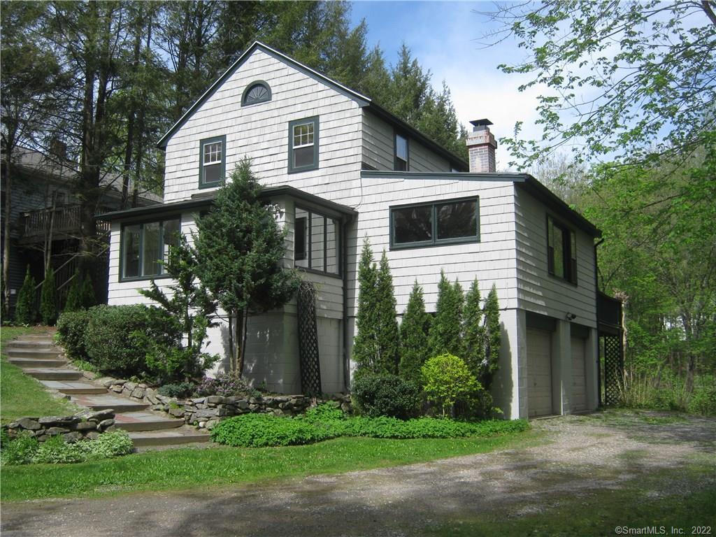 42 Stevens Road Middlebury, CT 06762 - Photo 1 of 1 Front with 2 car basement garage and deck on rear.