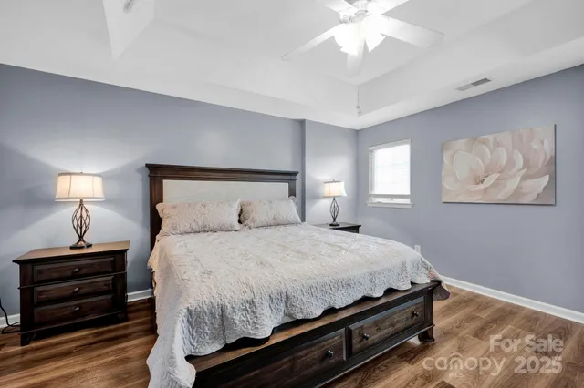 a bedroom with a bed and a chandelier