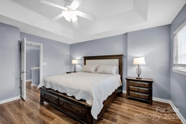 a bedroom with bed and a chandelier