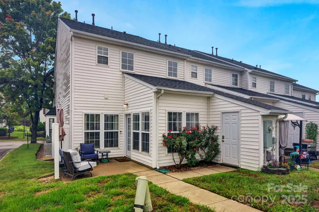 a view of a house with backyard sitting area and garden