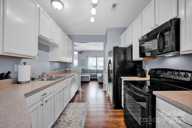 a kitchen with stainless steel appliances a stove microwave and refrigerator