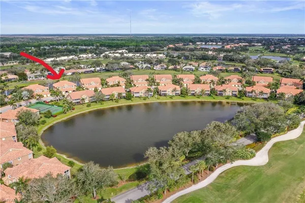 an aerial view of residential houses with outdoor space and seating