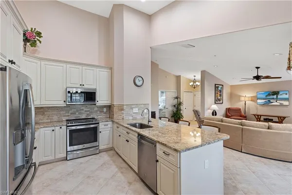 a kitchen with a sink stove and refrigerator