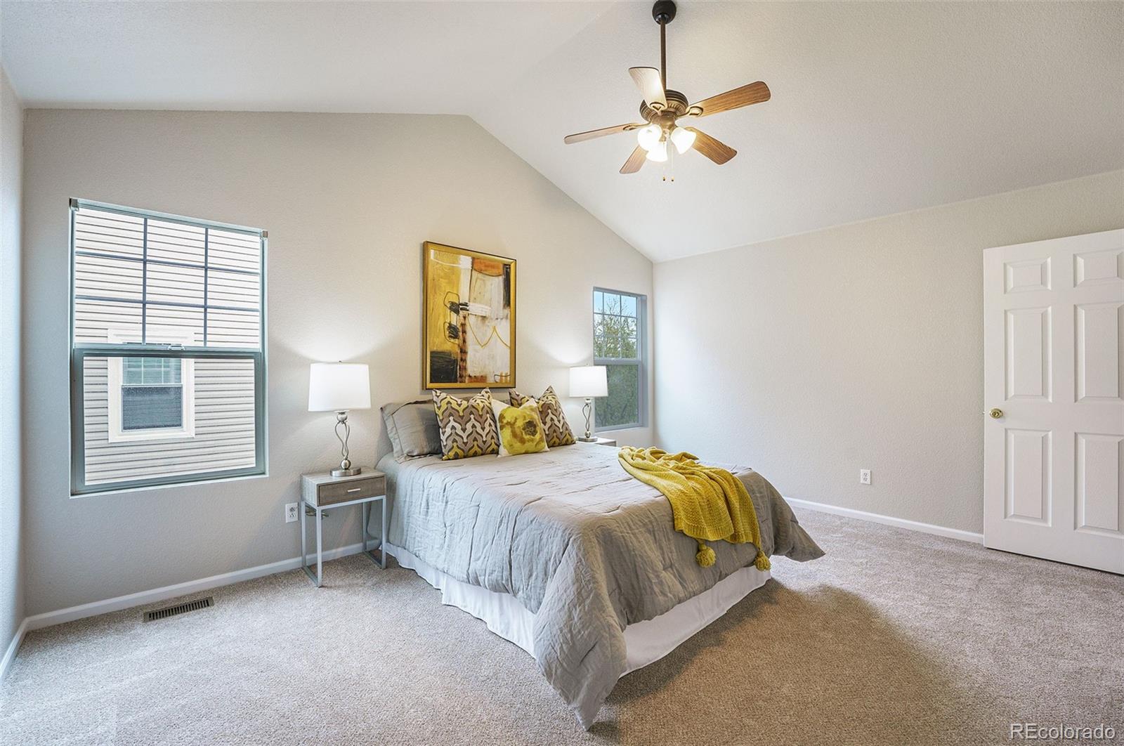 4623 Flower Street Wheat Ridge, CO 80033 - Photo 11 of 23 a bedroom with a bed ceiling fan and a window