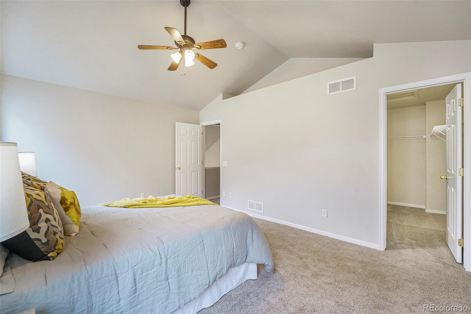 4623 Flower Street Wheat Ridge, CO 80033 - Photo 12 of 23 a bedroom with a bed and a ceiling fan