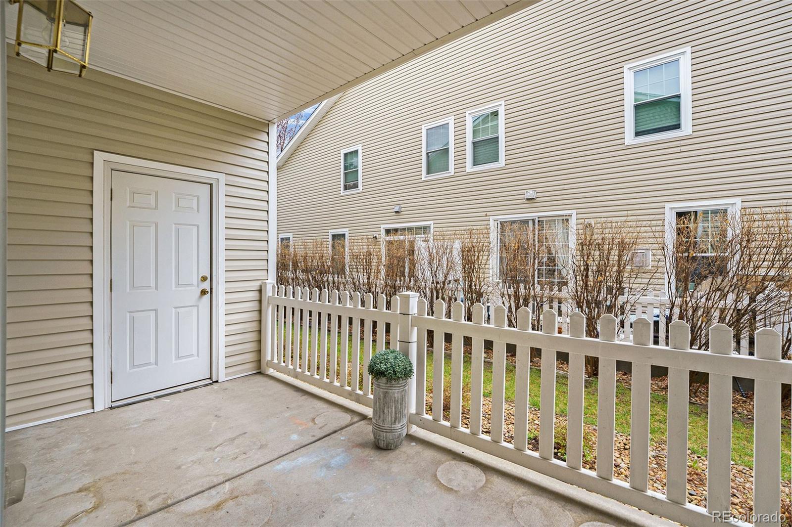 4623 Flower Street Wheat Ridge, CO 80033 - Photo 18 of 23 a view of a house with porch and wooden floor