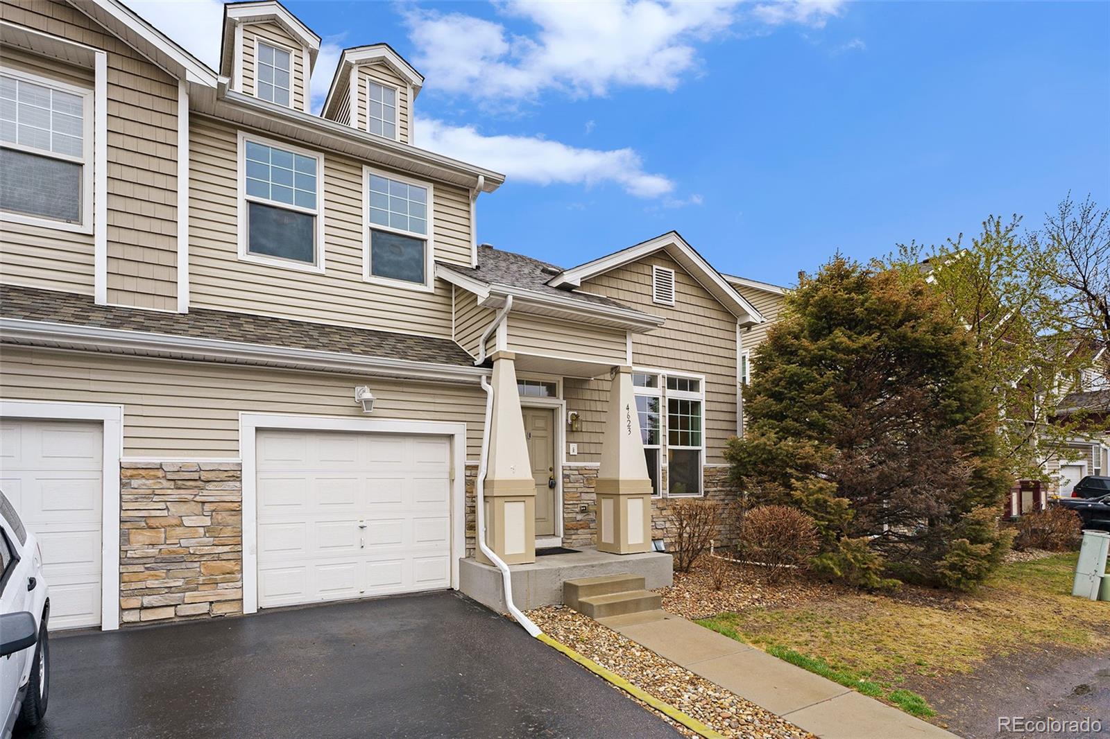 4623 Flower Street Wheat Ridge, CO 80033 - Photo 20 of 23 front view of a house with a yard