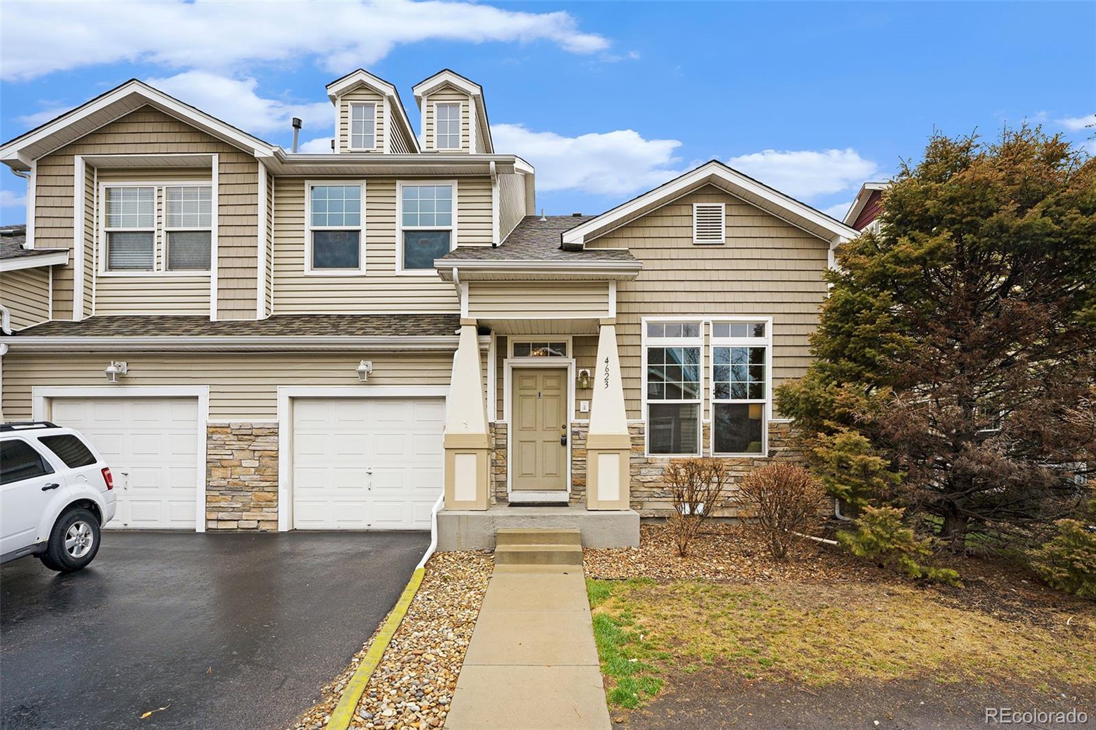 4623 Flower Street Wheat Ridge, CO 80033 - Photo 2 of 23 a view of a car park in front of house