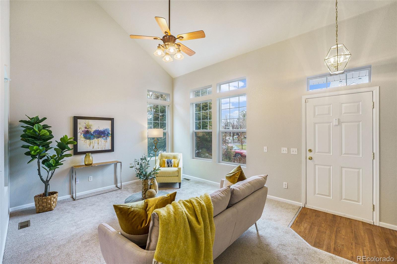 4623 Flower Street Wheat Ridge, CO 80033 - Photo 3 of 23 a living room with furniture and a chandelier