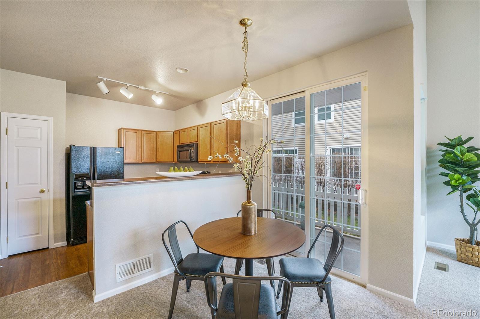 4623 Flower Street Wheat Ridge, CO 80033 - Photo 5 of 23 a view of a dining room with furniture window and wooden floor