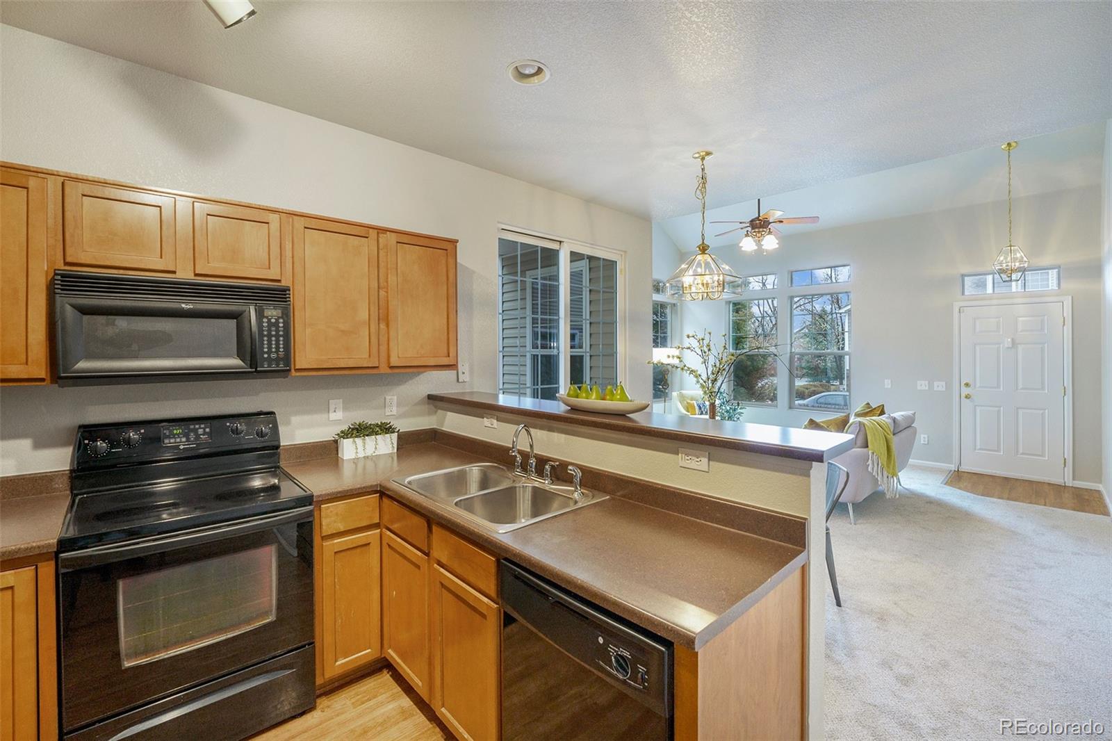 4623 Flower Street Wheat Ridge, CO 80033 - Photo 7 of 23 a kitchen that has a sink and a stove