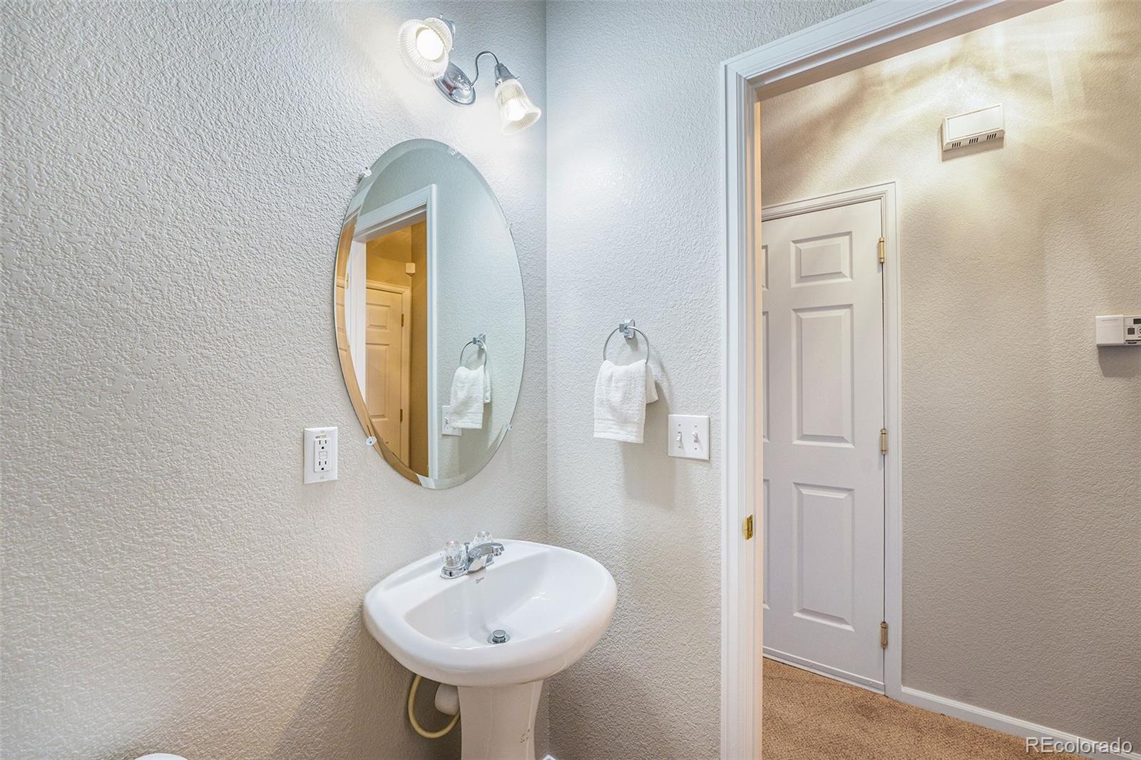 4623 Flower Street Wheat Ridge, CO 80033 - Photo 9 of 23 a bathroom with a sink and a mirror