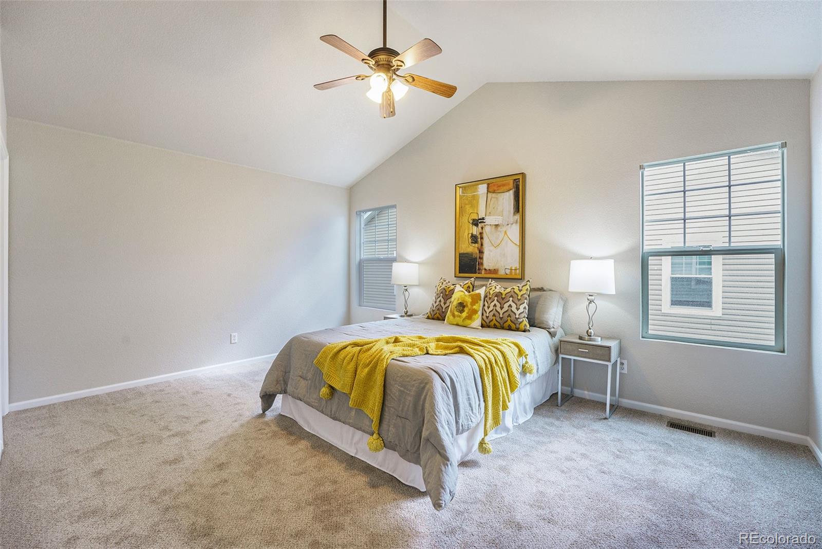 4623 Flower Street Wheat Ridge, CO 80033 - Photo 10 of 23 a bedroom with a bed and a chandelier