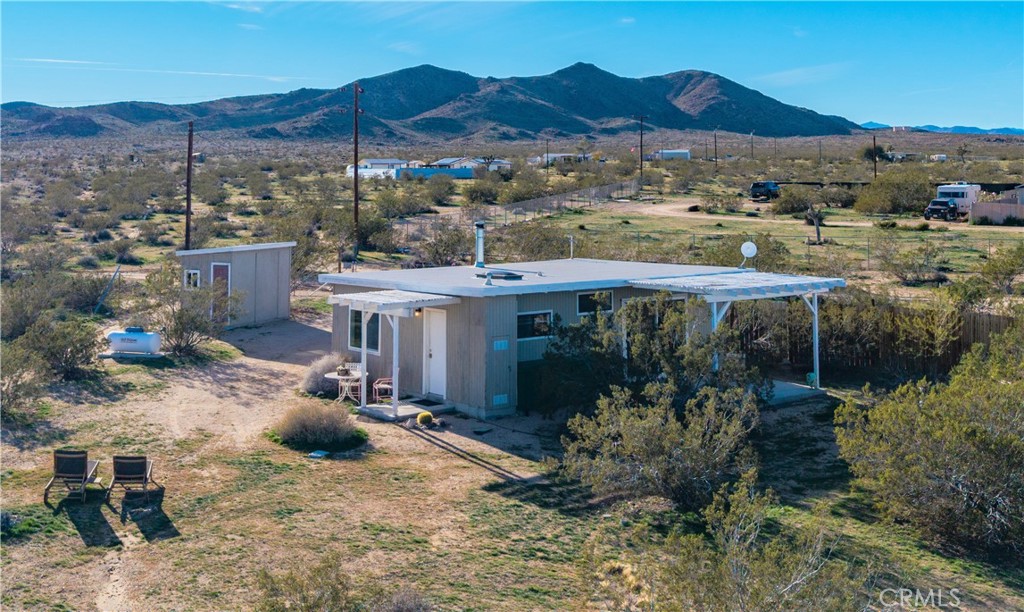an aerial view of a house with a yard basket ball court and outdoor seating