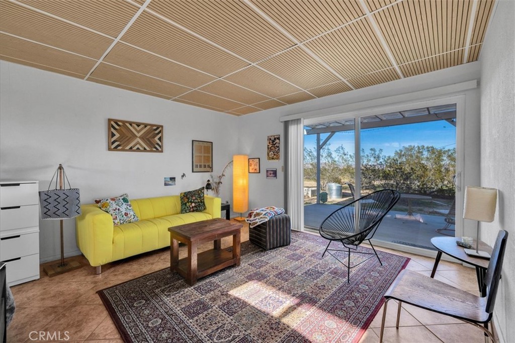 437 Mallow Road Landers, CA 92285 - Photo 12 of 52 a living room with furniture and a large window