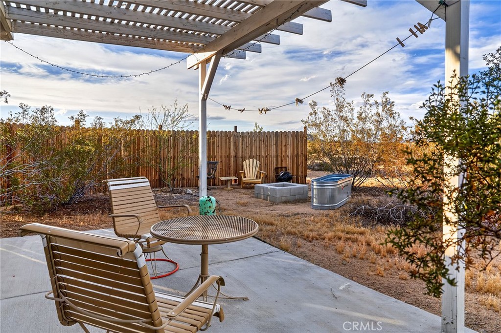 437 Mallow Road Landers, CA 92285 - Photo 27 of 52 a backyard of a house with table and chairs