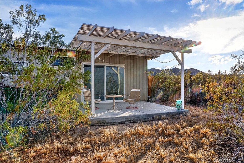 437 Mallow Road Landers, CA 92285 - Photo 29 of 52 a view of a patio with table and chairs under an umbrella